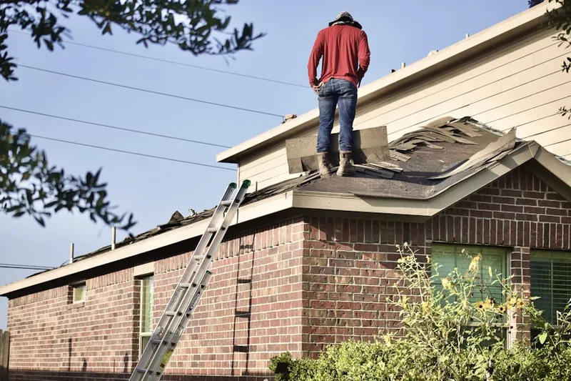 Professional roofer working on a residential roof in Sienna Vista